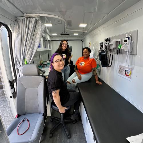 A group of women sit inside the van